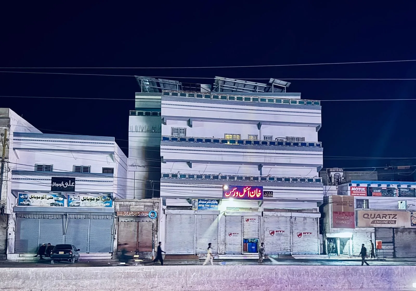 Night exterior of Khan Oil Works on Landhi Road, Karachi